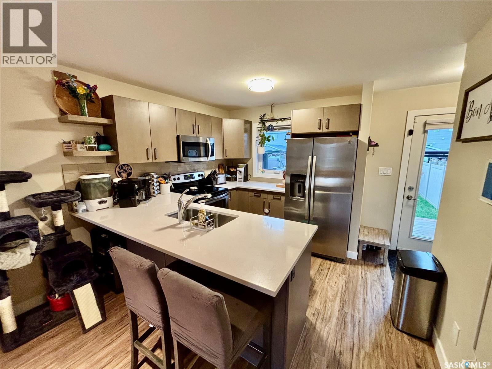 7989 Canola Avenue, Regina, SK - Indoor Photo Showing Kitchen With Double Sink