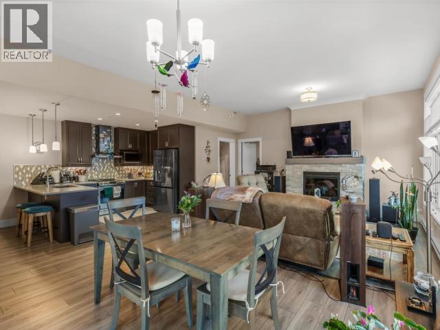 405-38 Waterfront Place, Whitehorse, YT - Indoor Photo Showing Dining Room With Fireplace