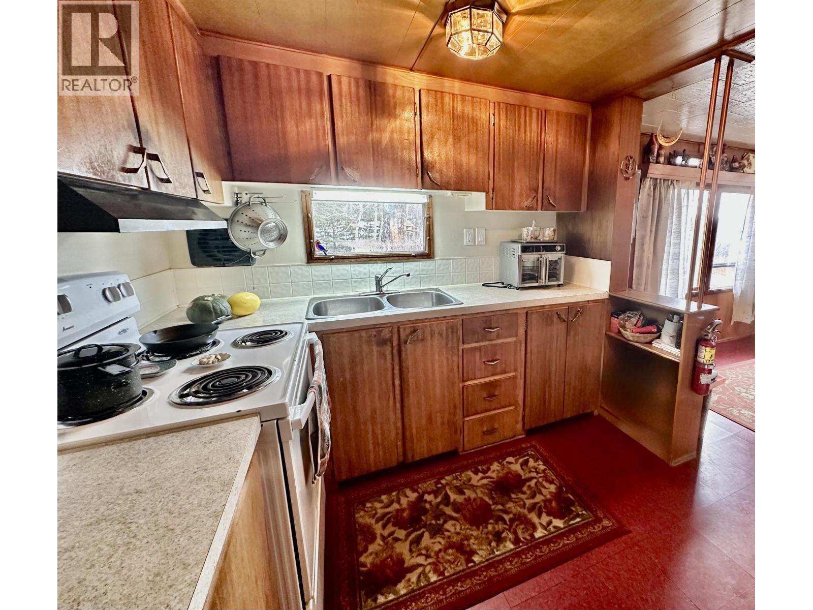 6808 Stokes Road, 100 Mile House, BC - Indoor Photo Showing Kitchen With Double Sink