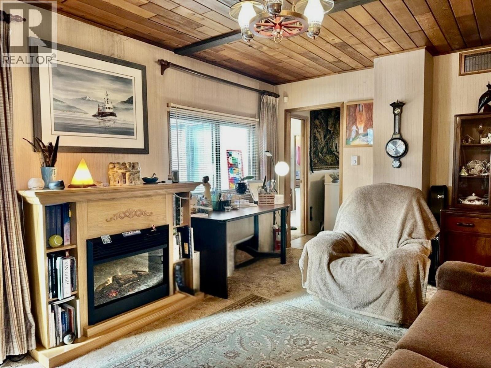 6808 Stokes Road, 100 Mile House, BC - Indoor Photo Showing Living Room With Fireplace