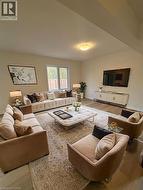 Living area featuring light wood-style floors and baseboards -