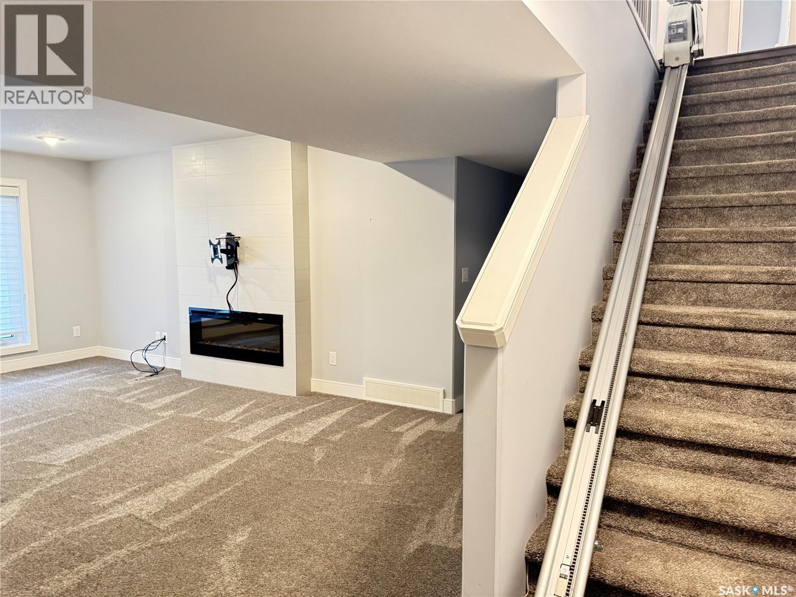 21 103 Pohorecky Crescent, Saskatoon, SK - Indoor Photo Showing Other Room With Fireplace