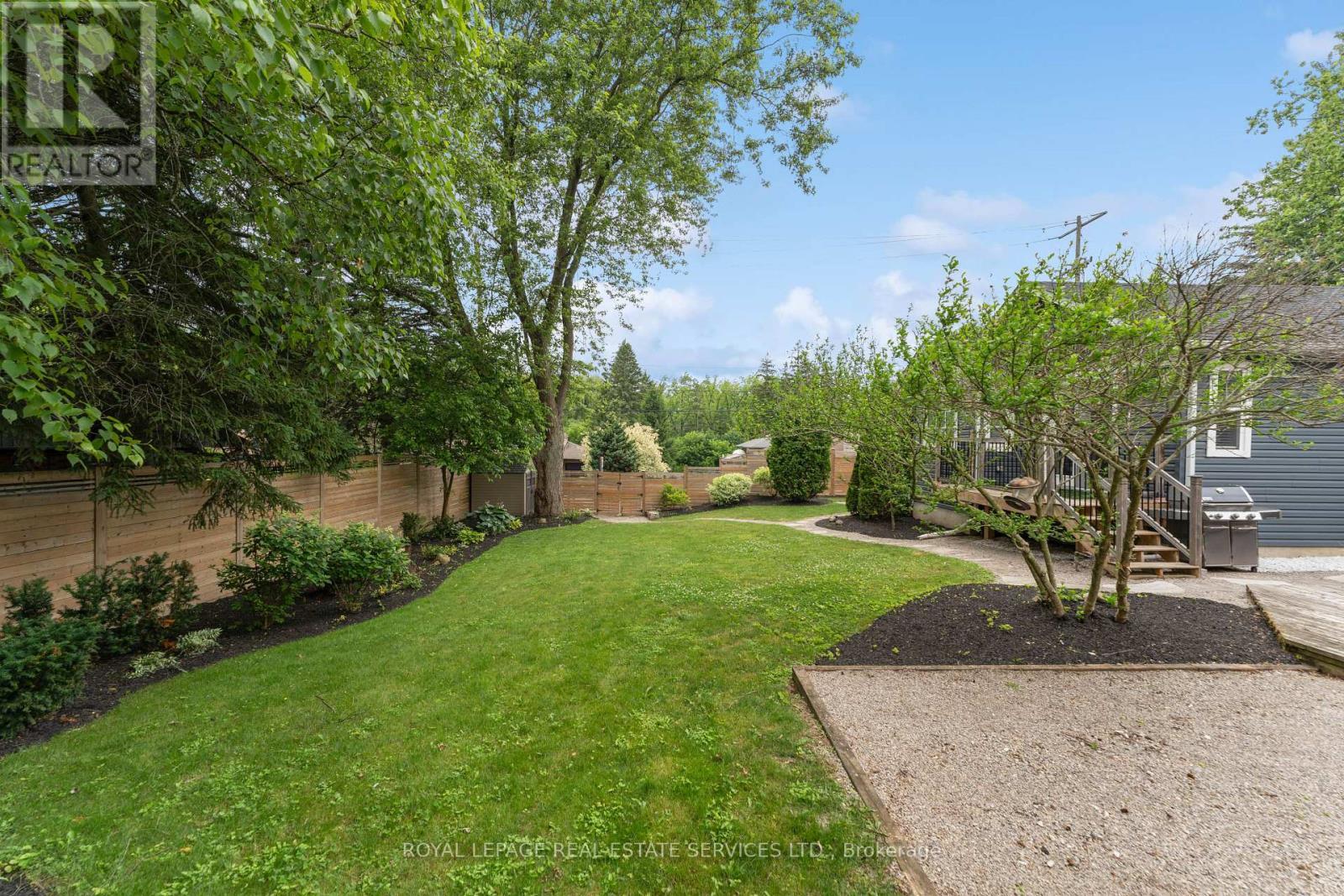 Enjoy an Expansive South-Facing Fenced Backyard - 136 Mohawk Road, Hamilton, ON - Outdoor With Backyard