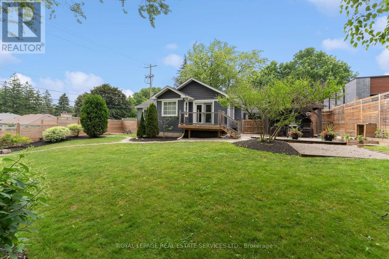 Enjoy an Expansive South-Facing Fenced Backyard - 136 Mohawk Road, Hamilton, ON - Outdoor With Deck Patio Veranda