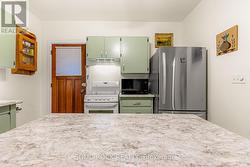 Kitchen-Centre island with stove, rangehood/fridge -