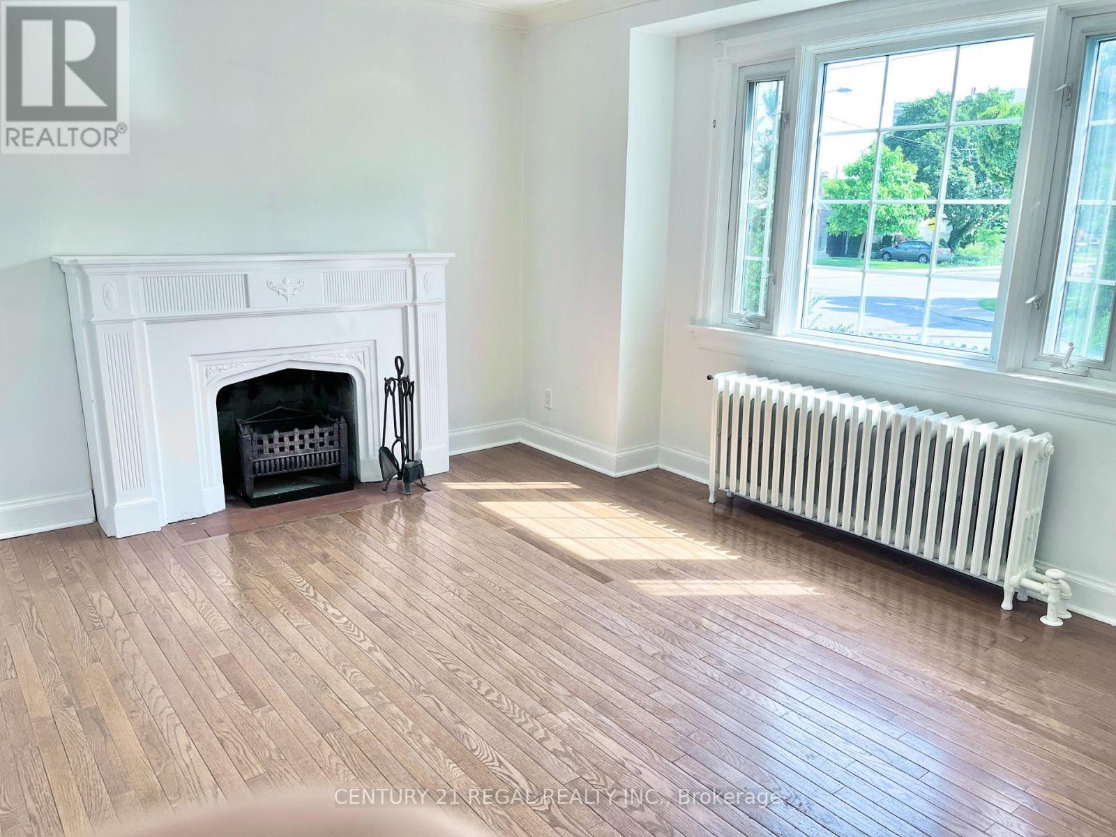 Living Room - 493 Plains Road, Toronto, ON - Indoor With Fireplace