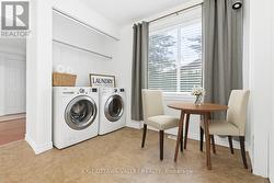 Eat in kitchen plus laundry area virtually staged -