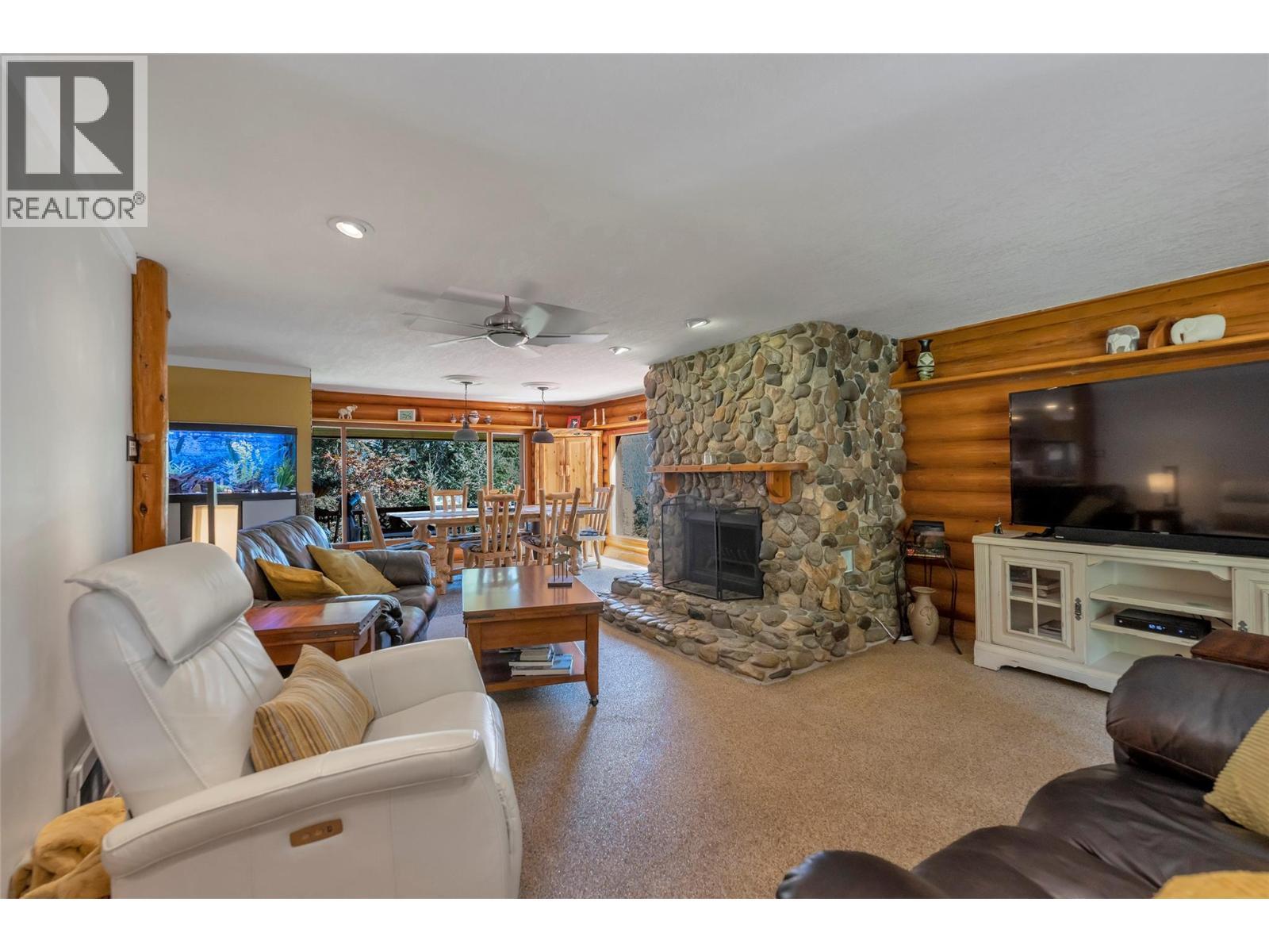 Hand build rock fireplace - 2726 Tranquil Place, Blind Bay, BC - Indoor Photo Showing Living Room With Fireplace