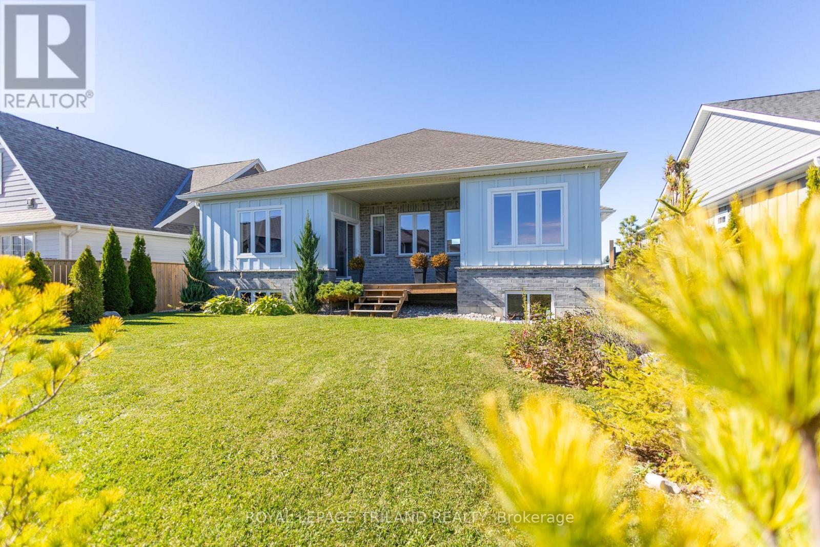 Covered deck overlooking well landscaped backyard - 26 Tattersall Lane, Lambton Shores (Grand Bend), ON - Outdoor With Deck Patio Veranda