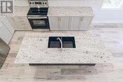 Leathered granite in kitchen is a classy feature -