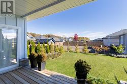 Sundeck overlooking mostly fenced-in yard -