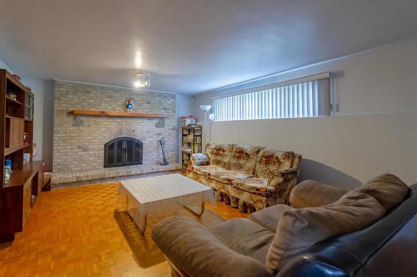 Basement - 7240 Rue Turner, Brossard, QC - Indoor Photo Showing Living Room With Fireplace