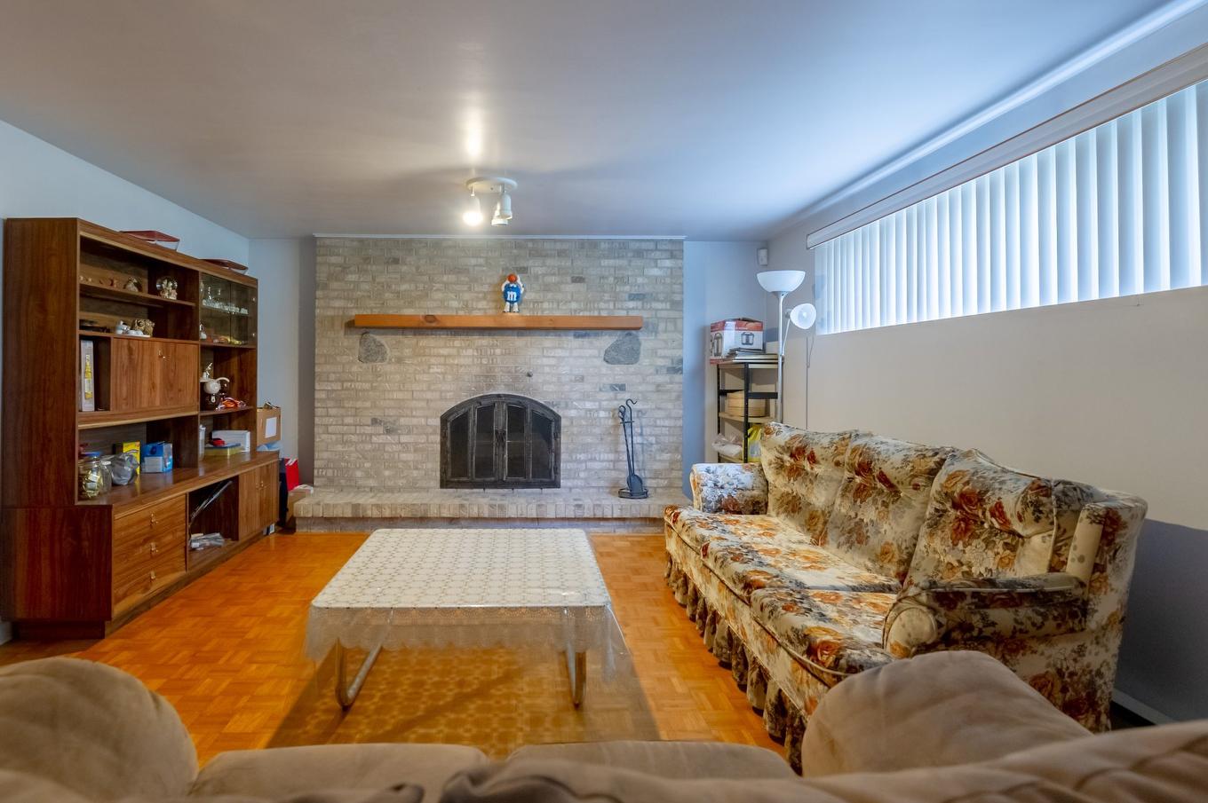 Basement - 7240 Rue Turner, Brossard, QC - Indoor Photo Showing Living Room With Fireplace