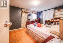 Bedroom featuring light wood-type flooring and baseboards -