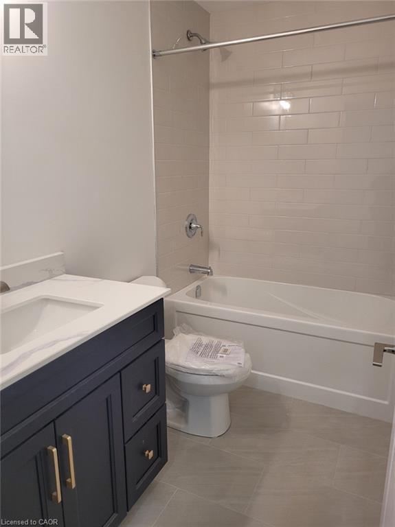 Full bathroom featuring vanity, shower combination, and light tile patterned flooring - 269 Dumfries Avenue Unit# Main, Kitchener, ON - Indoor Photo Showing Bathroom