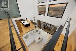 Upper level hallway overlooks the 30 foot ceilings of the main living space -