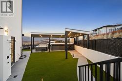 Side yard with syn lawn featuring an outdoor shower, covered hot tub/swim spa, with gas rough ins for outdoor kitchen/BBQ -