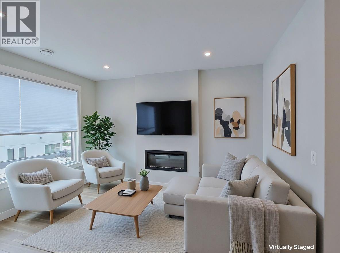 2110 11 Avenue Ne Unit# B205, Salmon Arm, BC - Indoor Photo Showing Living Room With Fireplace