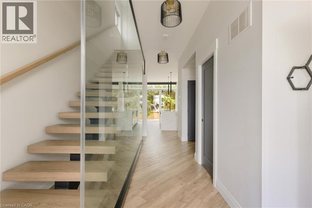 Stairway featuring wood finished floors - 26 Huron Street, Grand Bend, ON - Indoor Photo Showing Other Room