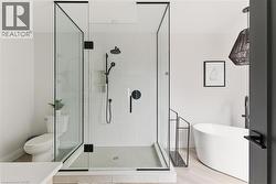 Full bathroom with a freestanding bath, a stall shower, and vanity -
