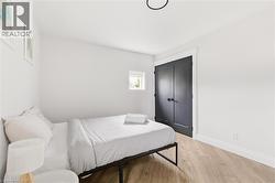 Bedroom with light wood-style flooring and a closet -