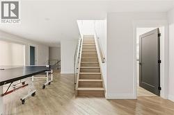 Stairway with wood finished floors and baseboards -