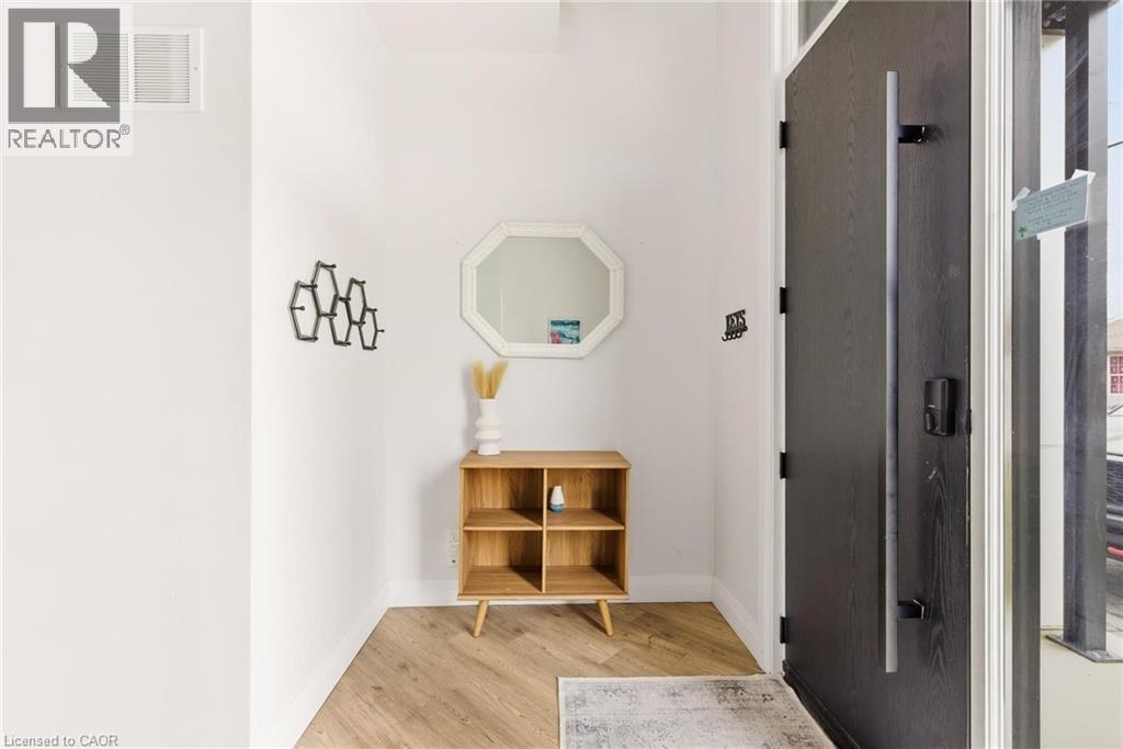 Corridor with light wood-style flooring and baseboards - 26 Huron Street, Grand Bend, ON - Indoor Photo Showing Other Room
