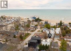 Aerial overview of property's location featuring nearby suburban area and expansive coastline -