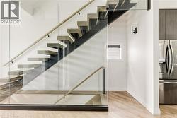 Staircase featuring wood finished floors and baseboards -