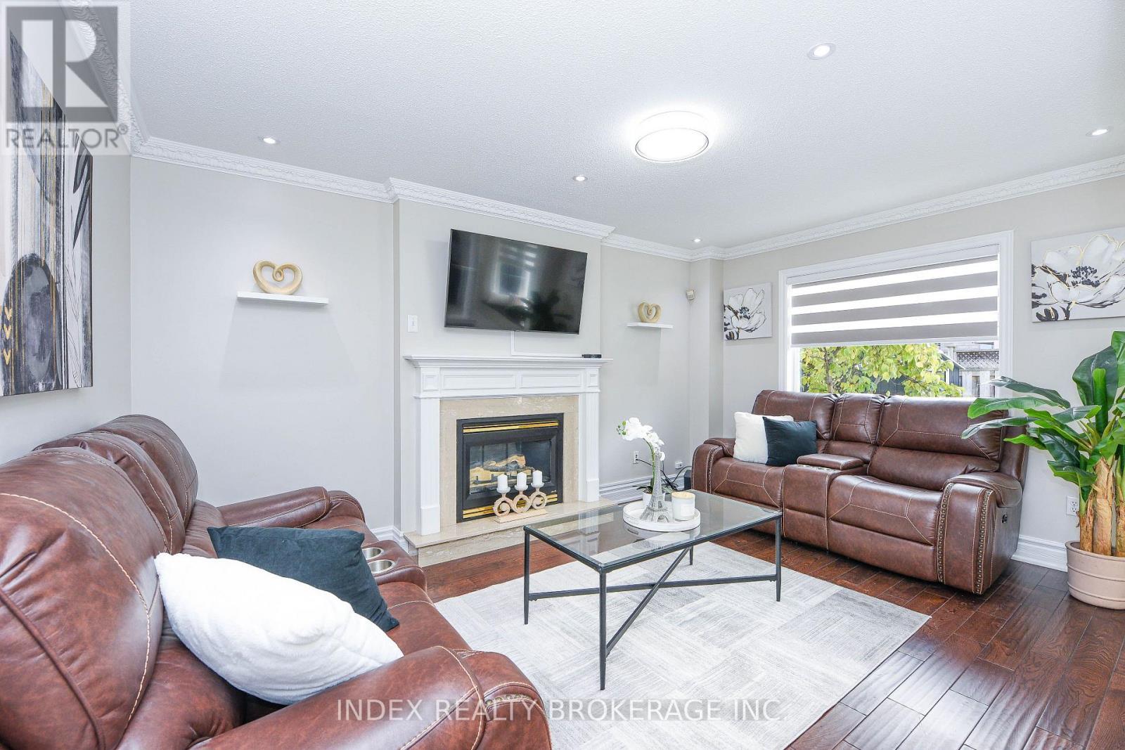 10 Leopard Gate, Brampton, ON - Indoor Photo Showing Living Room With Fireplace