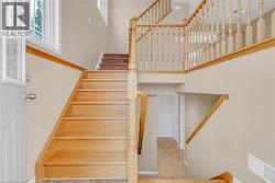 Staircase with a towering ceiling and baseboards -