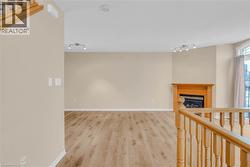 Hall with track lighting and light wood-type flooring -