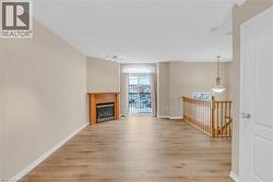 Living room featuring light wood finished floors and a glass covered fireplace -