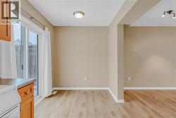 Unfurnished dining area featuring baseboards and light wood finished floors -