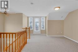 Additional living space with a textured ceiling, light carpet, and lofted ceiling -