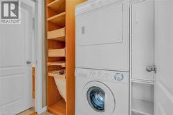 Laundry area featuring stacked washer / drying machine -