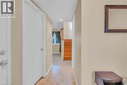 Hallway featuring stairway and recessed lighting -