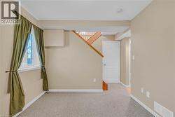 Spare room with light carpet and stairway -