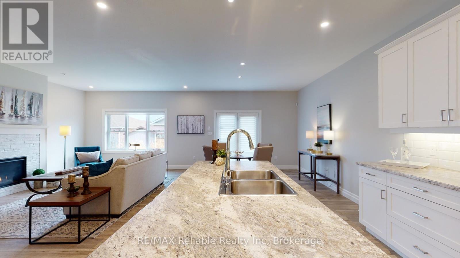 7 Thimbleweed Drive, Bluewater (Bayfield), ON - Indoor Photo Showing Kitchen With Fireplace With Double Sink With Upgraded Kitchen