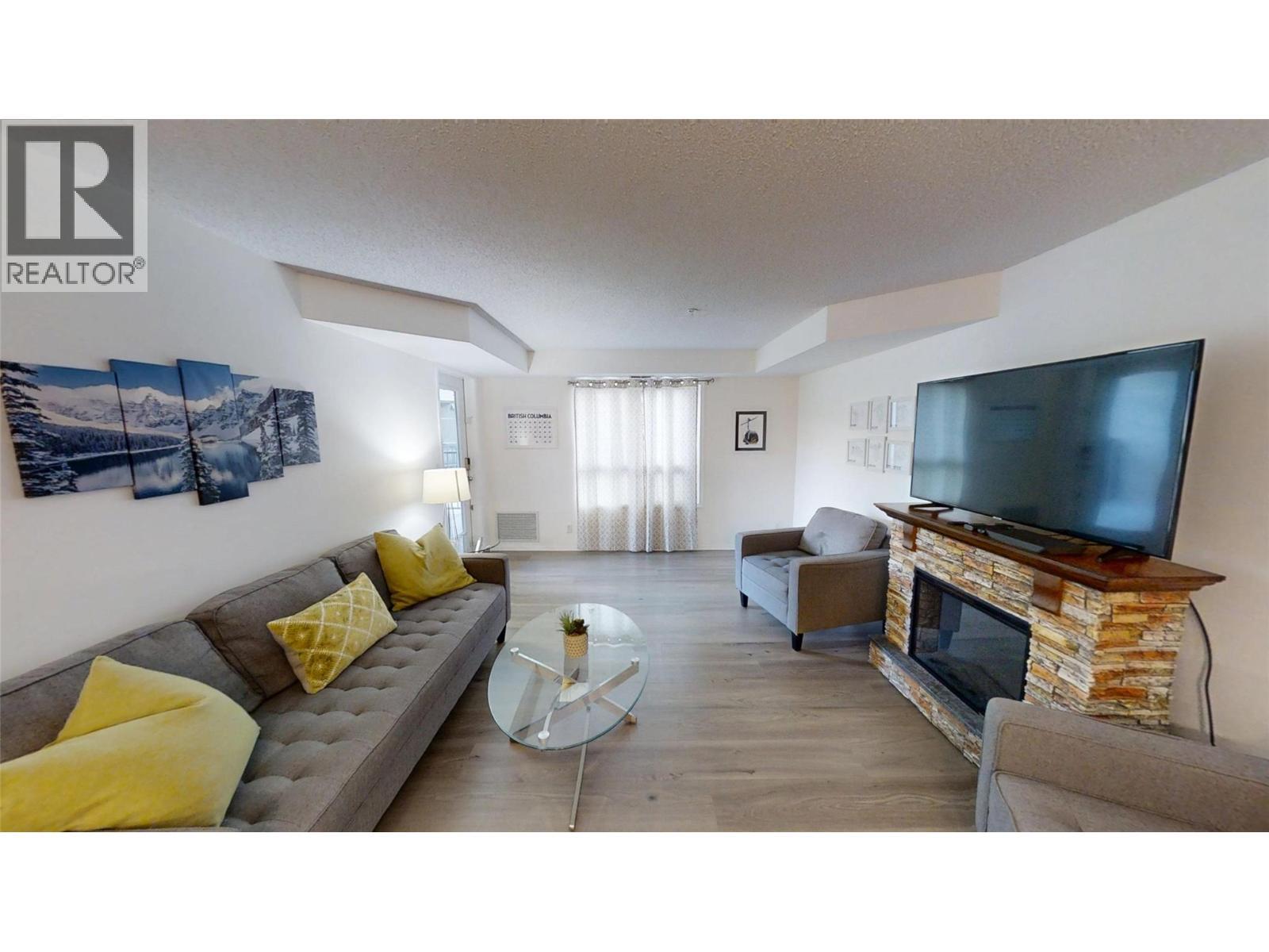 205 Third Avenue Unit# 3117, Invermere, BC - Indoor Photo Showing Living Room With Fireplace