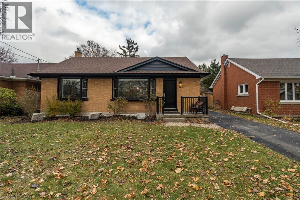 View of front of home featuring brick siding, a porch, a chimney, and a front yard - 266 Melrose Avenue, Kitchener, ON - Outdoor