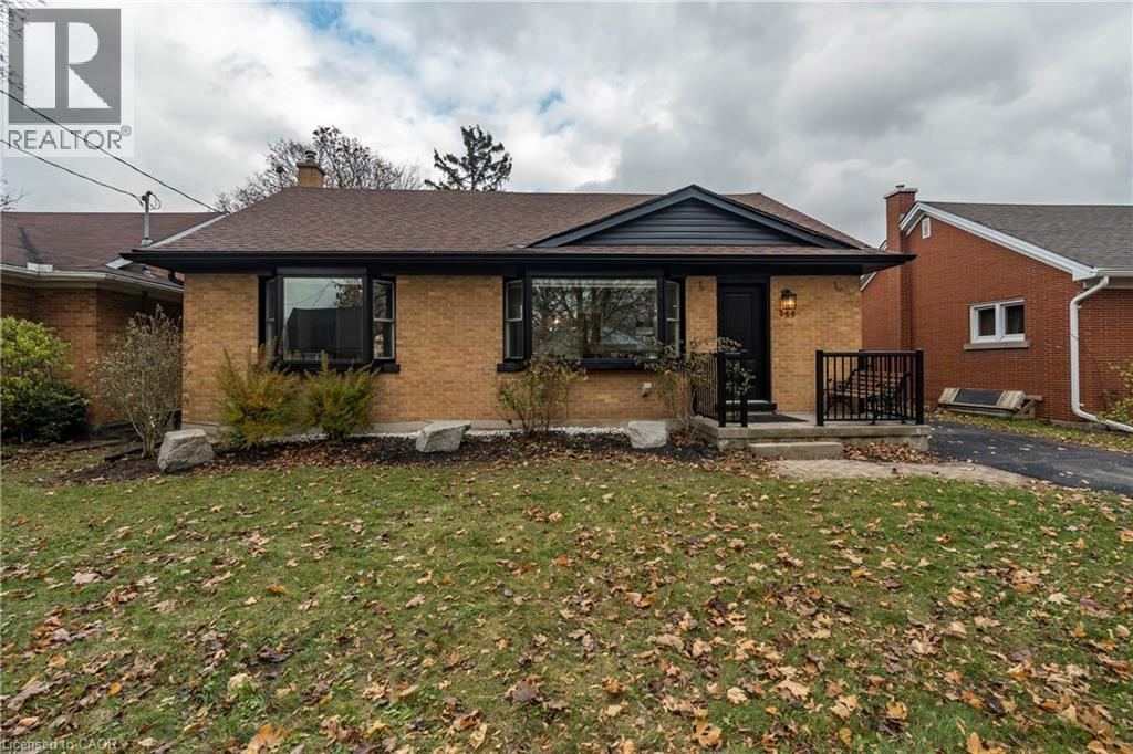 View of front facade with a front yard, brick siding, covered porch, a chimney, and roof with shingles - 266 Melrose Avenue, Kitchener, ON - Outdoor