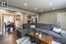 Living room with recessed lighting and hardwood / wood-style flooring -