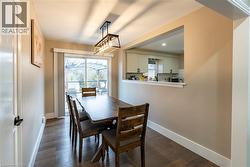 Dining area with dark wood finished floors and baseboards -