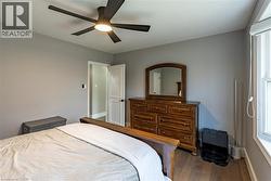 Bedroom featuring dark wood-style floors and ceiling fan -