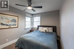 Bedroom featuring wood finished floors and ceiling fan -