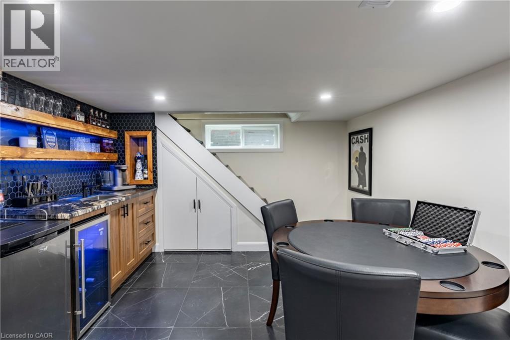 Indoor wet bar featuring open shelves, beverage cooler, tasteful backsplash, stairway, and brown cabinets - 266 Melrose Avenue, Kitchener, ON - Indoor