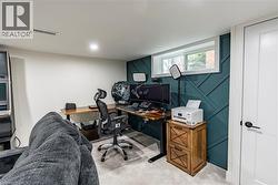 Office with carpet floors and a decorative wall -