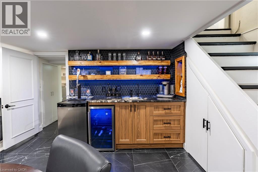 Indoor wet bar featuring open shelves, brown cabinets, wine cooler, and stairway - 266 Melrose Avenue, Kitchener, ON - Indoor Photo Showing Other Room