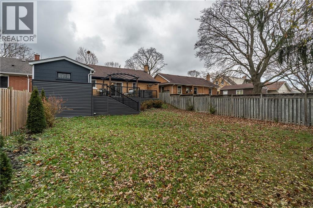 Back of property with a fenced backyard and a wooden deck - 266 Melrose Avenue, Kitchener, ON - Outdoor